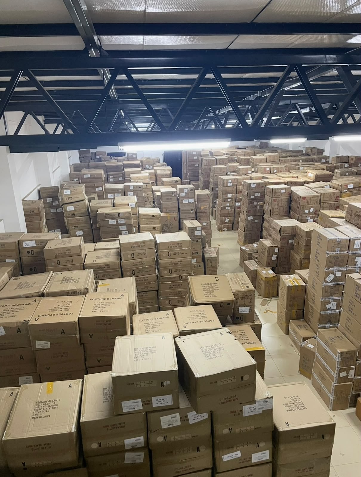 Rows of stacked inventory cartons inside a warehouse